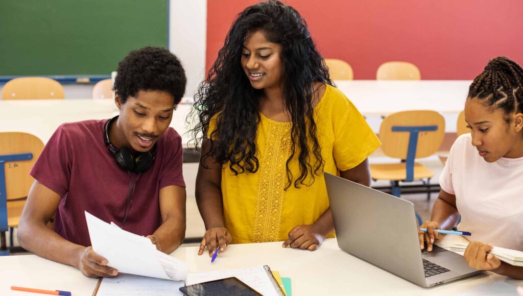 3college students different ethnicities cramming
