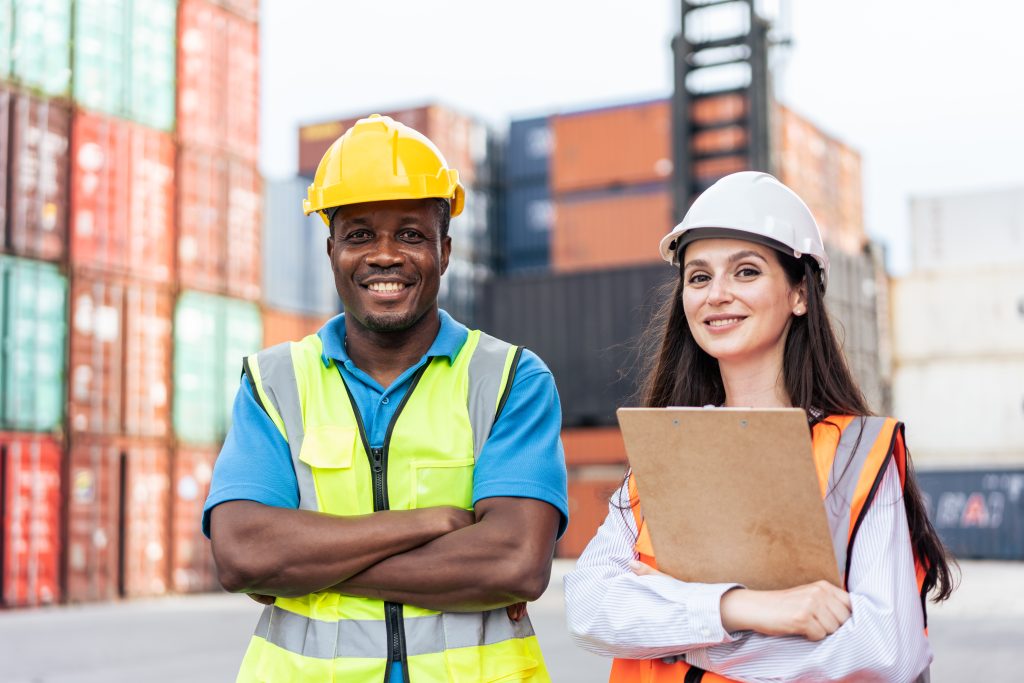 smiling port workers standing in front of containe 2026 03 24 21 59 14 utc